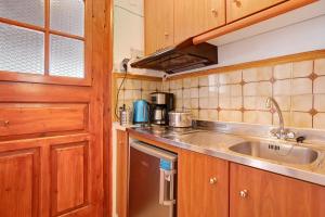 a kitchen with a sink and a counter top at Areti Orfeas Apartment 7 in Vasilikos +20 photos
