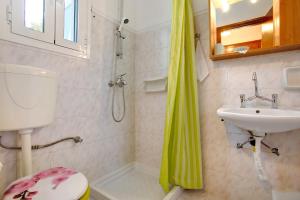 a bathroom with a sink and a toilet and a shower at Areti Orfeas Apartment 7 in Vasilikos