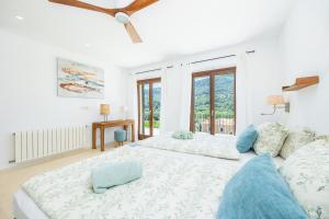 a large bedroom with two beds and a couch at Sa Papaiona in Valldemossa +29 photos