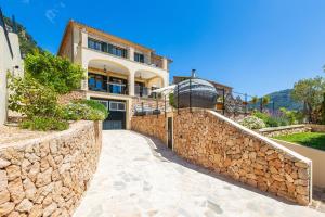 a large house with a stone wall at Sa Papaiona in Valldemossa