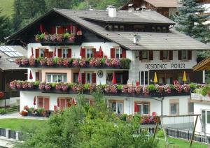 a large white building with flower boxes on it at Residence Pichler Apartment 7 in San Leonardo in Passiria