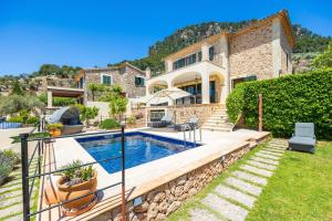 a villa with a swimming pool and a house at Sa Papaiona in Valldemossa