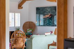 a living room with a green couch and chairs at Surfers Roost in Croyde +42 photos