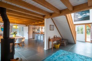 a kitchen and living room with a stove at Surfers Roost in Croyde