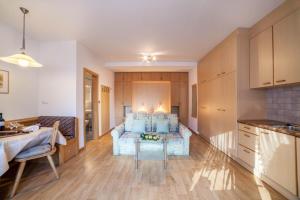 a living room with a couch and a table at Residence Pichler Apartment 7 in San Leonardo in Passiria