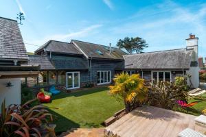an exterior view of a house with a yard at Surfers Roost in Croyde