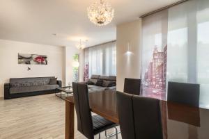 a living room with a dining table and a couch at Familien-Apartment 6 in Meersburg