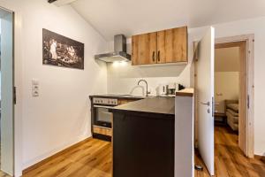 a kitchen with a sink and a stove at Bergwelt B in Niederau