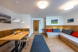 a living room with a couch and a table at Gass Apartment B in Laion +27 photos