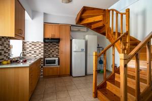 a kitchen with a staircase and a refrigerator at Afroksilia Villa Gardenia in Lefkada
