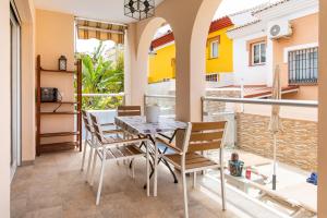 a dining room with a table and chairs on a balcony at Villa Palomas in Nerja