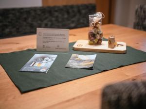 a table with a green table cloth with a vase on it at Zum Sonnentor App Larix 2 in Lutago