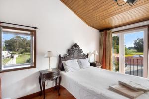 a bedroom with a bed and a large window at Casa de Barqueiros in Barqueiros +37 photos