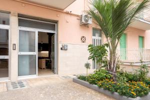 a house with a palm tree in front of it at La Casa di Laura in Putignano