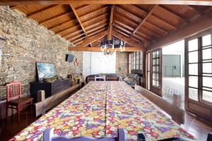 a large quilt in the middle of a room at Casa de Barqueiros in Barqueiros