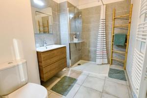 a bathroom with a shower and a toilet and a sink at Senyo Cocoon in Seignosse