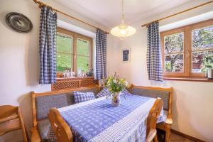 a dining room with a table with flowers on it at Ferienhaus Rauchegg - Seeblick in San Pancrazio dʼUltimo +31 photos