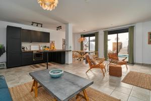 a kitchen and a living room with a table at El Cine in Canillas de Albaida