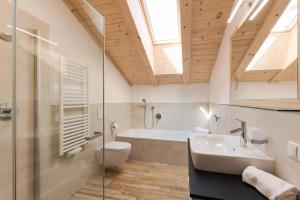 a bathroom with a sink and a toilet and a tub at Natur Suite Edelweisshof App Tony in Chiusa +10 photos