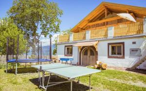 a ping pong table in the yard of a house at Stettnerhof Wohnung Ifinger in Vollan