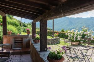 a patio with a fireplace and tables and chairs at Universal Harmony - Pettirosso in Dicomano