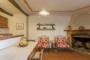 a kitchen with a table and chairs and a fireplace at Universal Harmony - Pettirosso in Dicomano