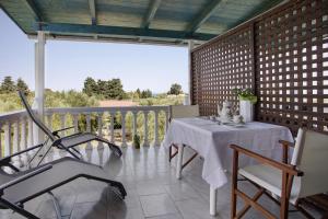 a patio with a table and chairs on a balcony at Areti Orfeas Studio in Vasilikos