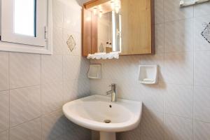 a bathroom with a sink and a mirror at Areti Orfeas Studio in Vasilikos