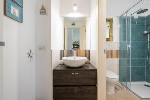 a bathroom with a sink and a toilet and a shower at Casa Cò in Costa Rei