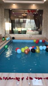 a swimming pool with balls in the water at فلل لوسيرن in Khamis Mushayt +14 photos