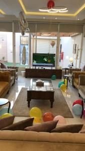 a living room with a couch and a tv at فلل لوسيرن in Khamis Mushayt