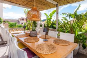 a wooden table with hats on it on a patio at Casa Varna in Capdepera