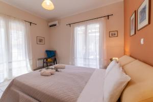a bedroom with a bed with two pillows on it at Villa Votistis A2 in Lefkada