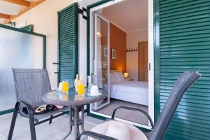 a room with a table and chairs and a bedroom at Villa Votistis A2 in Lefkada +22 photos