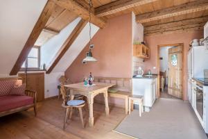 a kitchen and dining room with a table and a couch at Ferienwohnung Wachsbichl in Unterammergau +20 photos