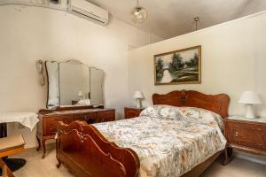 a bedroom with a bed and two dressers and a mirror at Makis Family Studio in Khionáta