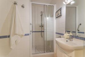 a bathroom with a shower and a sink and a shower at Sail Away in Quarteira +17 photos