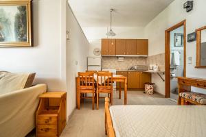 a kitchen and dining room with a table and chairs at Makis Family Studio in Khionáta +12 photos