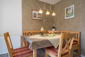 a dining room table with a bowl of fruit on it at Haus Schussenblick Og in Eriskirch