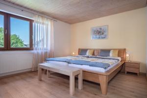 a bedroom with a large bed and a window at Haus Schussenblick Og in Eriskirch