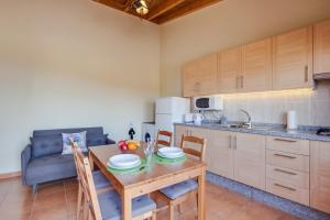 a kitchen with a table with chairs and a dining room at Casa Quemahierro 1 in Icod de los Vinos +19 photos