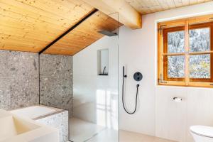 a bathroom with a shower and a toilet at Chalet Flocke Sternschnuppe in Sankt Anton am Arlberg