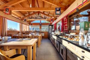 a restaurant with tables and a counter with food at Affittacamere De Charme Jour Et Nuit in Torgnon