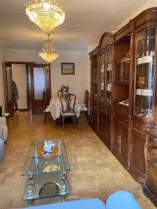 a living room with a glass table and a chandelier at Montes de Alhama Il in Soria