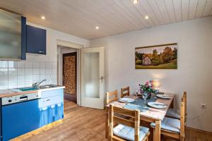 a kitchen and dining room with a table and chairs at Am Sersbach in Forbach +24 photos