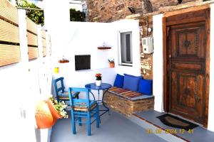 a porch with a table and chairs and a door at Mannas House in Émbonas