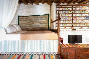 a bedroom with a bed and a tv in a room at Mannas House in Émbonas