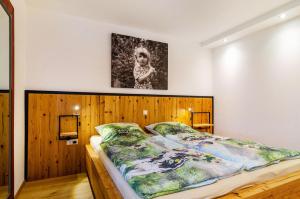 a bedroom with a large bed with a wooden headboard at Gästehaus Wüpping 1 in Salem
