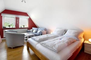 a bedroom with a bed and a table and a chair at Ferienwohnung Erichsen, Viöl in Viöl