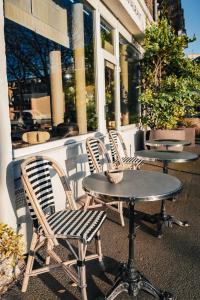 a group of chairs and tables in front of a store at Otonali hôtel by Breizh Café in Saint Malo